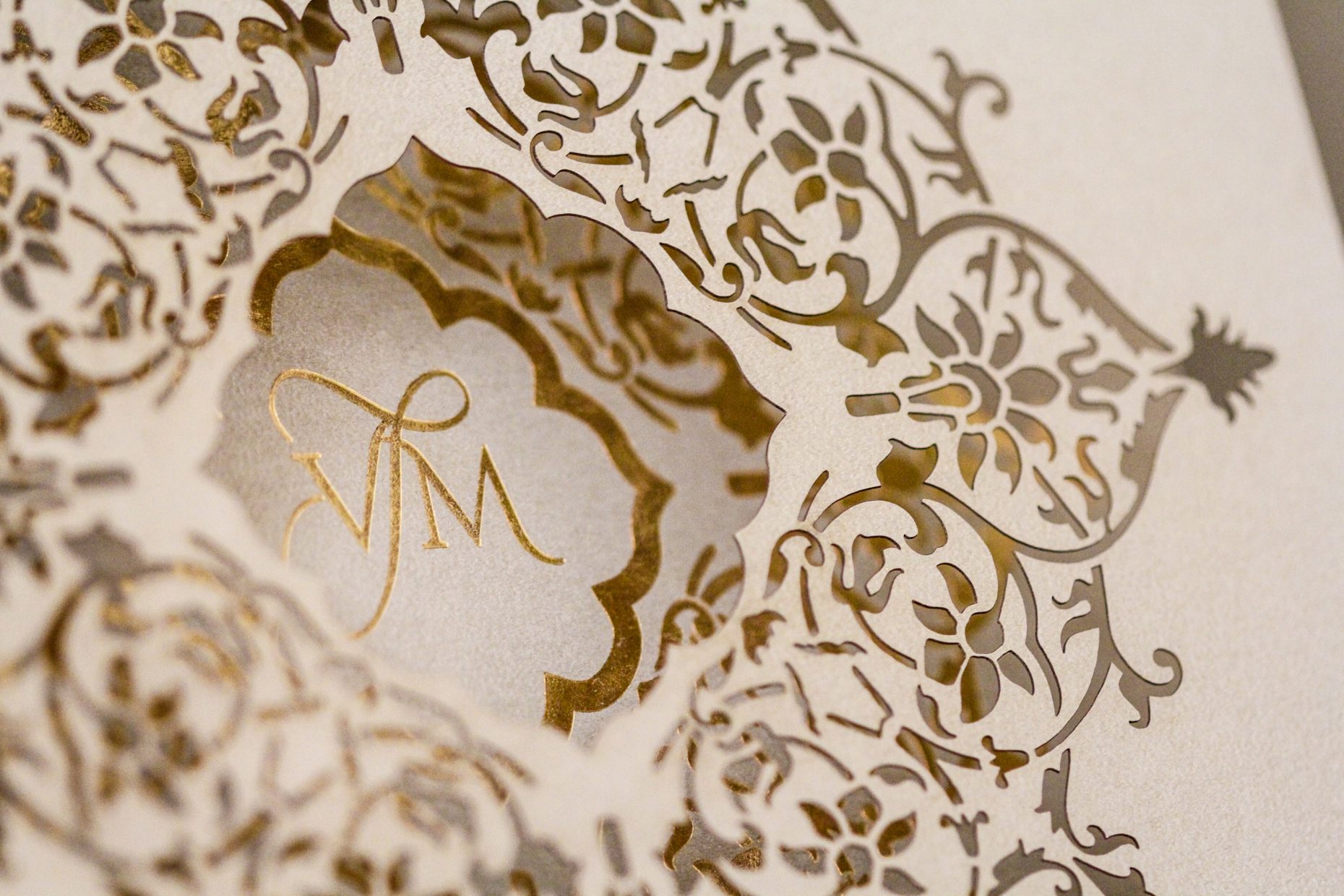 lasercut invitation with monogram in gold