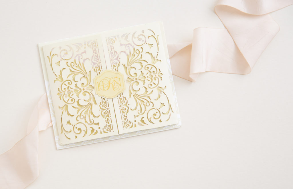 wedding invitation with ivory lasercut with gold accents