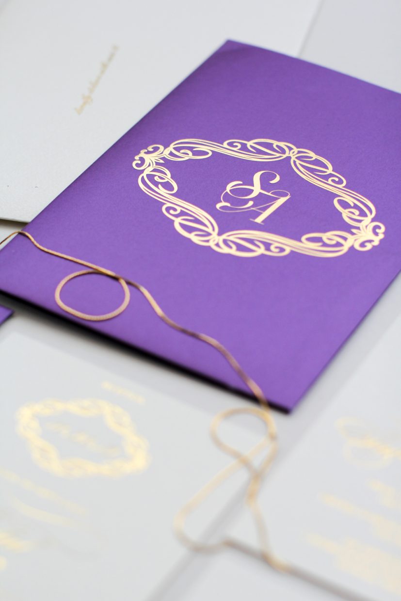 purple invitation with gold accents