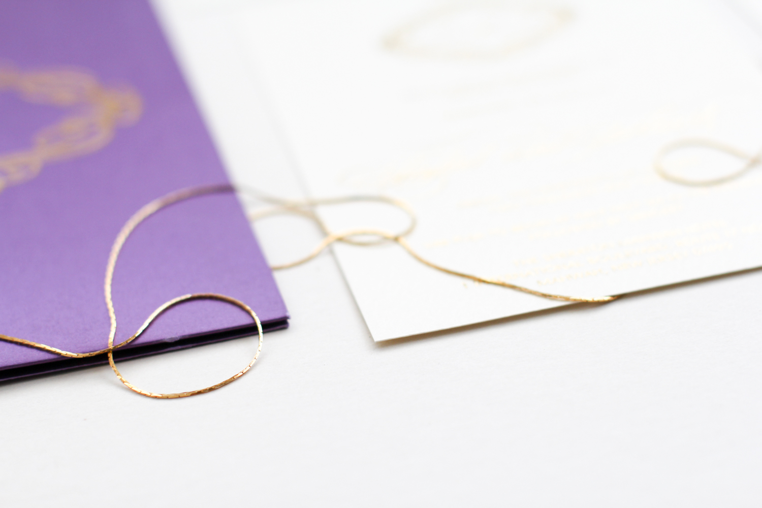ivory invite with purple folio