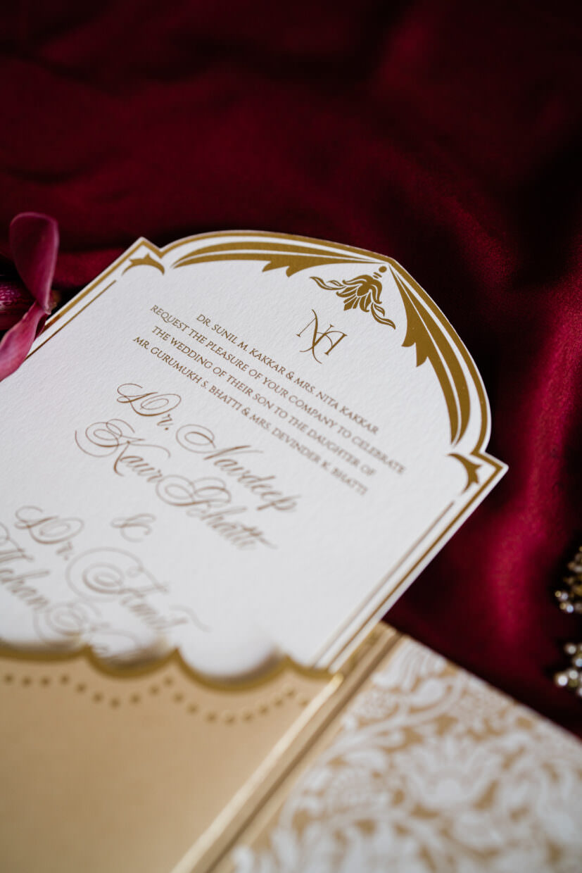 Image of designer wedding invitation with gold foil printing and custom pocket