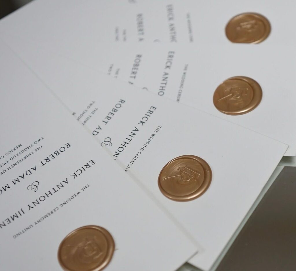 Atelier Azure wedding programs with a gold was seal