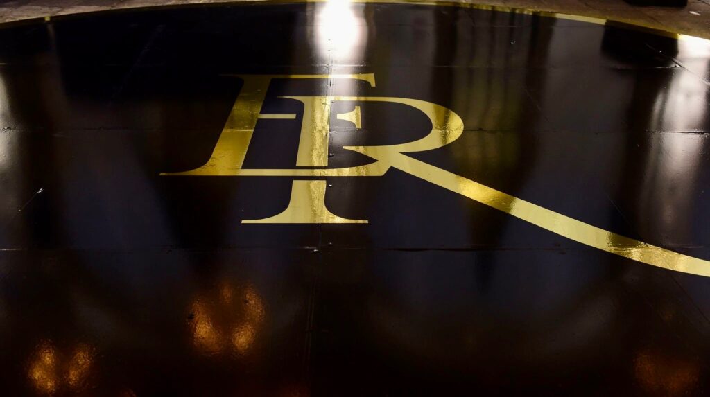 Wedding monogram printed in gold lettering on a black dance floor by Azure