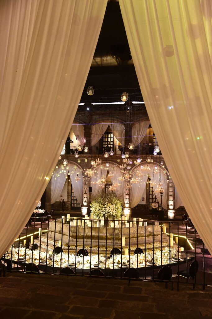 Draped curtain entrance leading into candlelit wedding reception
