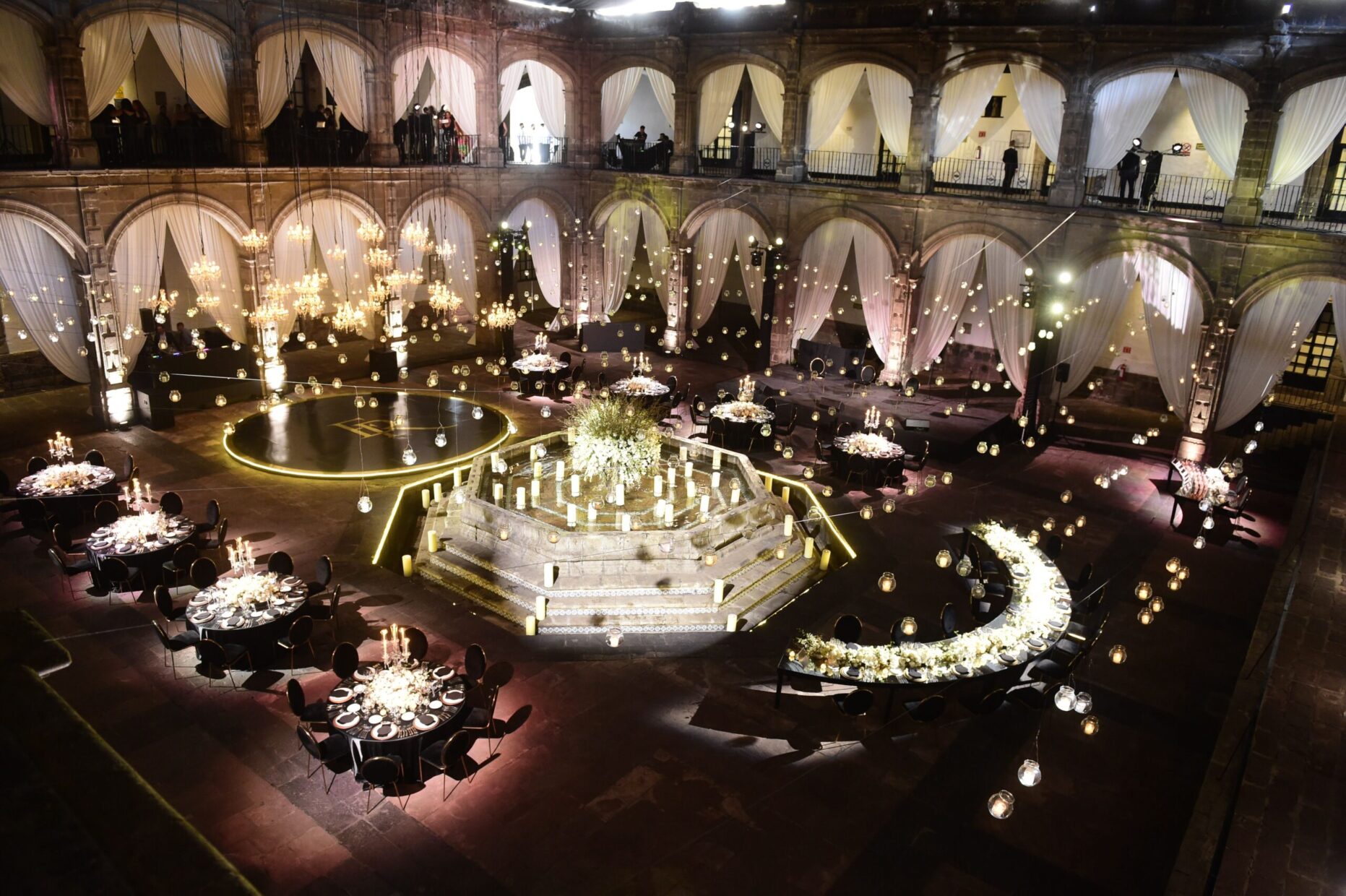 Ex Convento de San Hipolito Reception hall filled with chandeliers and white florals