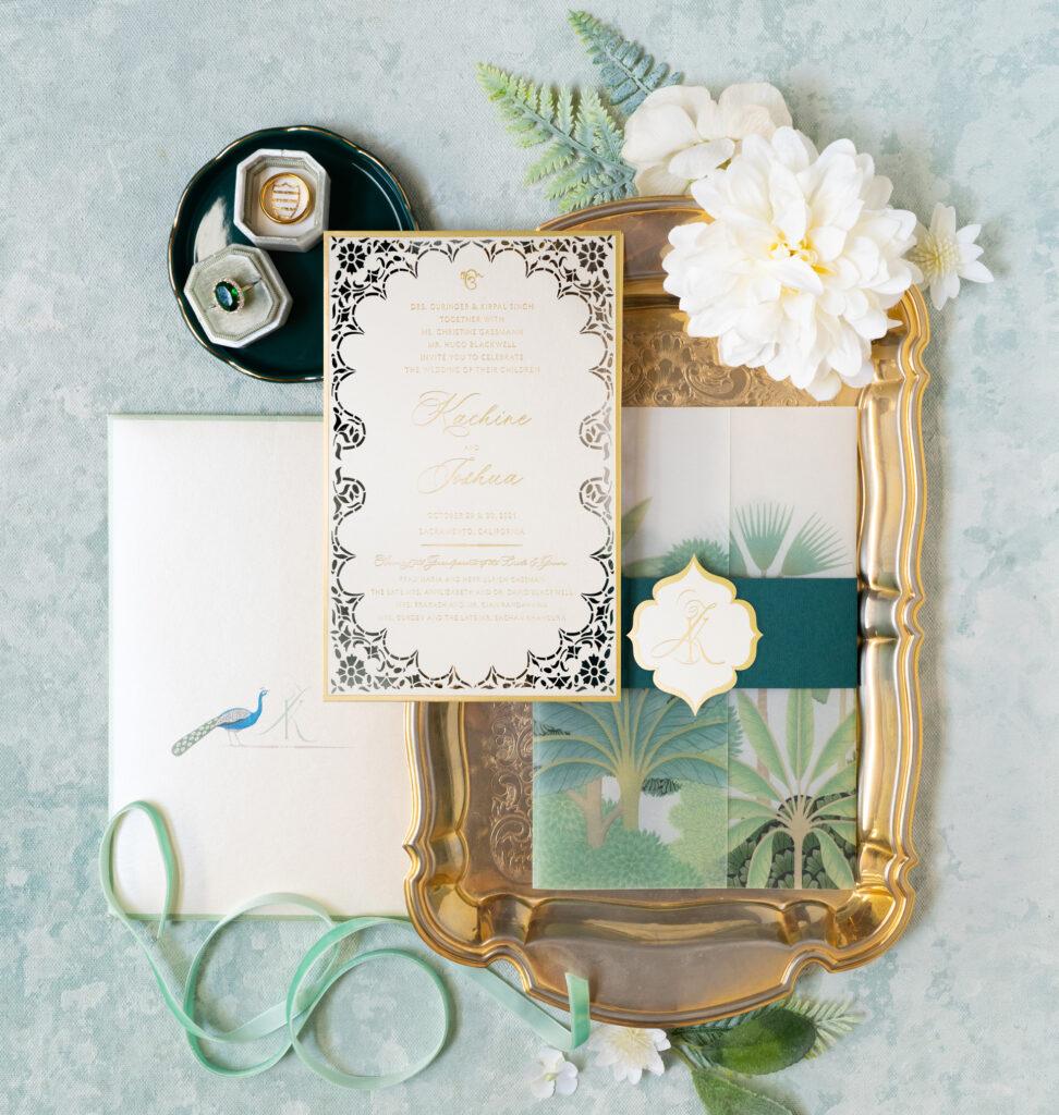 Lasercut invitation card in a green and gold themed tropical destination wedding suite