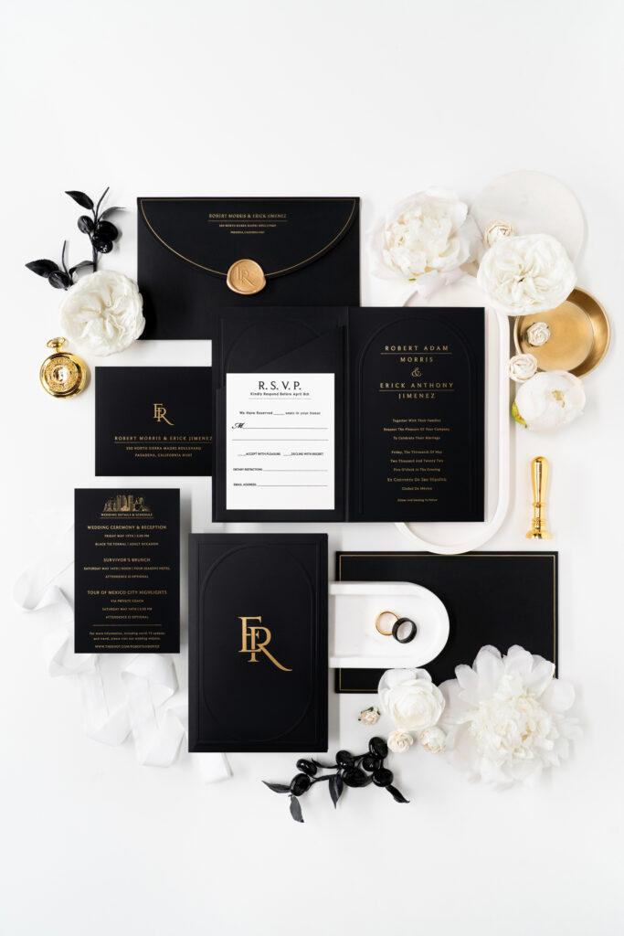 complete custom invitation suite in black and gold with modern embossed design